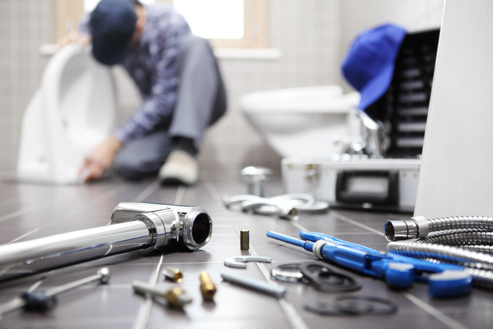 Professional Plumber Using Tools To Clear A Clogged Drain Hutto